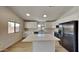 Modern kitchen featuring white cabinets, quartz countertops, and stainless steel appliances at 30629 N Royal Oak Way, San Tan Valley, AZ 85143