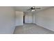 Well-lit bedroom with ceiling fan, neutral carpeting, and ample closet space at 30629 N Royal Oak Way, San Tan Valley, AZ 85143
