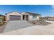 New home exterior with gray garage doors and landscaping at 25226 N 131St Dr, Peoria, AZ 85383