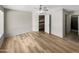 Large bedroom with wood-look floors and access to bathroom at 2617 W Willow Ave, Phoenix, AZ 85029