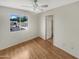 Bedroom with wood floors, a ceiling fan and a view of the community at 2617 W Willow Ave, Phoenix, AZ 85029