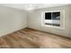 Spacious bedroom featuring wood-look floors and a large window at 2617 W Willow Ave, Phoenix, AZ 85029
