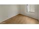 Simple bedroom with wood-look floors and a window at 2617 W Willow Ave, Phoenix, AZ 85029