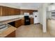 Galley kitchen with wood cabinets, tile floors and modern appliances at 2617 W Willow Ave, Phoenix, AZ 85029