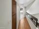Light and airy hallway with wood flooring and access to other rooms at 2617 W Willow Ave, Phoenix, AZ 85029