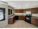 Kitchen with dark wood cabinets, tile floors, and stainless steel appliances at 2617 W Willow Ave, Phoenix, AZ 85029