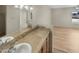 Bathroom boasts a vanity with tiled countertop and mirror at 2617 W Willow Ave, Phoenix, AZ 85029