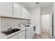 Laundry room with washer, dryer, sink, and cabinets at 2425 W Bronco Butte Trl # 2017, Phoenix, AZ 85085