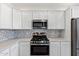 Modern kitchen with white cabinets and stainless steel appliances at 2425 W Bronco Butte Trl # 2017, Phoenix, AZ 85085