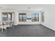 Spacious living room with gray carpet and large windows at 2425 W Bronco Butte Trl # 2017, Phoenix, AZ 85085
