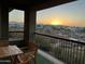 Sunset view from a patio with wooden table and chairs at 2425 W Bronco Butte Trl # 2017, Phoenix, AZ 85085