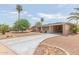 Ranch home with a gravel driveway and mature trees at 5323 E Covina Rd, Mesa, AZ 85205