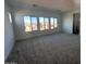 Bright bedroom with neutral carpeting and large windows offering neighborhood views at 22794 E Stacey Rd, Queen Creek, AZ 85142