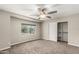 Bright bedroom with ceiling fan, carpet, and ample closet space at 8672 E Edgemont Ave, Scottsdale, AZ 85257