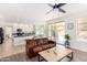 Open living room with leather sofas and sliding doors to the patio at 6761 W Sonnet Dr, Glendale, AZ 85308