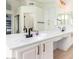 Double vanity bathroom with white cabinets and a soaking tub at 6761 W Sonnet Dr, Glendale, AZ 85308