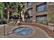 Community hot tub with brick wall and lounge chair at 1701 E Colter St # 291, Phoenix, AZ 85016