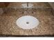 Close-up of a bathroom vanity with granite countertop and sink at 1701 E Colter St # 291, Phoenix, AZ 85016