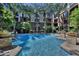 Community pool with surrounding landscaping and building view at 1701 E Colter St # 291, Phoenix, AZ 85016