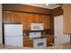 Kitchen with wood cabinets, granite counters, and appliances at 1701 E Colter St # 291, Phoenix, AZ 85016
