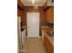 Kitchen with wood cabinets, granite counters, and appliances at 1701 E Colter St # 291, Phoenix, AZ 85016