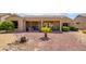 Backyard with desert landscaping, featuring a water feature and covered patio at 18000 N Estrella Vista Dr, Surprise, AZ 85374
