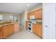View of kitchen with double oven, granite counters, and wood cabinets at 18000 N Estrella Vista Dr, Surprise, AZ 85374