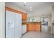 Kitchen boasts granite countertops, wood cabinets, and a large refrigerator at 18000 N Estrella Vista Dr, Surprise, AZ 85374