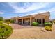 Backyard view of house with desert landscaping and covered patio at 18000 N Estrella Vista Dr, Surprise, AZ 85374