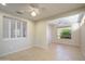 Bright dining area with tile floors, window shutters, and ceiling fan at 18000 N Estrella Vista Dr, Surprise, AZ 85374