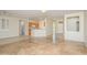 Open living space with tile flooring, kitchen island and access to other rooms at 18000 N Estrella Vista Dr, Surprise, AZ 85374
