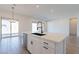 Modern kitchen with white cabinets, island, and black faucet at 18944 W Ocotillo Rd, Waddell, AZ 85355