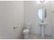 Powder room with pedestal sink, toilet and oval mirror at 6728 N 190Th Dr, Waddell, AZ 85355