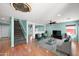 Bright living room with hardwood floors and two comfy armchairs at 43341 W Blazen Trl, Maricopa, AZ 85138