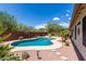 Relaxing kidney shaped pool with flagstone patio and desert landscaping at 6744 S Haunted Canyon Rd, Gold Canyon, AZ 85118