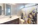 Clean bathroom with shower, toilet and dark vanity at 10611 E Tumbleweed Ave, Mesa, AZ 85212