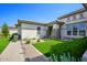 Single-story home with landscaped front yard, paver walkway, and artificial turf at 10611 E Tumbleweed Ave, Mesa, AZ 85212