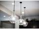 Three glass pendant lights illuminating the kitchen island at 10611 E Tumbleweed Ave, Mesa, AZ 85212