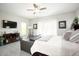 Main bedroom with king bed, sitting area, and TV at 10611 E Tumbleweed Ave, Mesa, AZ 85212