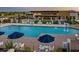 Inviting community pool with ample lounge chairs and umbrellas at 10611 E Tumbleweed Ave, Mesa, AZ 85212