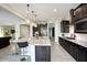 Open concept kitchen with large island and dark wood cabinets at 10611 E Tumbleweed Ave, Mesa, AZ 85212