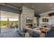 Spacious community lounge featuring a stone fireplace and outdoor access at 10611 E Tumbleweed Ave, Mesa, AZ 85212