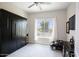 Guest bedroom with a wall bed, window, and TV at 10611 E Tumbleweed Ave, Mesa, AZ 85212