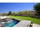 Spacious backyard with hot tub, putting green, and artificial turf at 10611 E Tumbleweed Ave, Mesa, AZ 85212