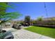 Outdoor kitchen and dining area with artificial turf at 10611 E Tumbleweed Ave, Mesa, AZ 85212