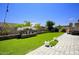 Artificial turf backyard with patio and water feature at 10611 E Tumbleweed Ave, Mesa, AZ 85212