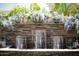 Serene backyard water feature with stone wall and lush plants at 10611 E Tumbleweed Ave, Mesa, AZ 85212