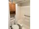 Clean bathroom with shower/tub combo, toilet, and wood cabinet at 1111 E University Dr # 135, Tempe, AZ 85288