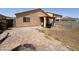 Backyard with covered patio, fire pit, and grassy area at 22005 W Cocopah St, Buckeye, AZ 85326