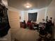 Bedroom with desk, carpeted floor and window at 22005 W Cocopah St, Buckeye, AZ 85326